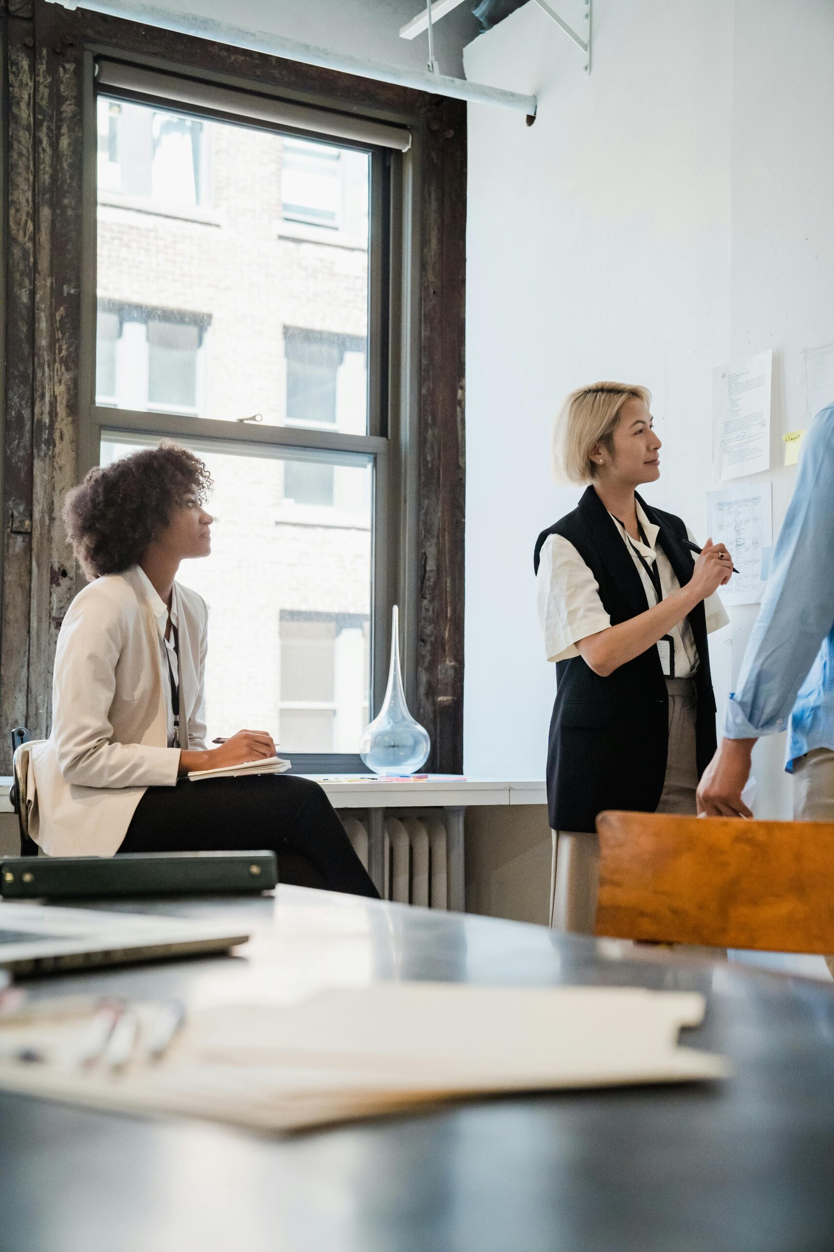 Professional team collaborating on a project in a well-lit office space.